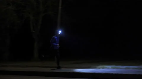 Runner with headlamp in urban Video stock 147269482