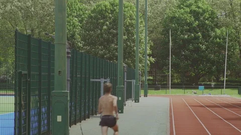 Runner in hot sun - Sprinkler spouts jets of water Stock Footage 93202839