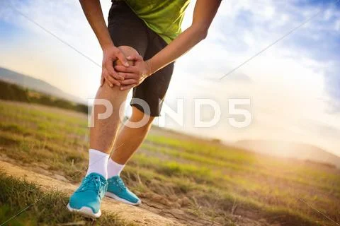 Runner with injured knee Stock Photos