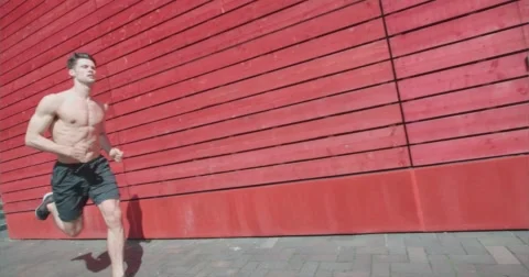 Runner jogging bare chested showing physique. Vídeo Stock 58872706