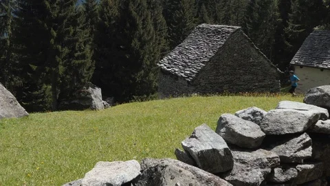 Runner jumps a wall and run in the meadow Stock-Footage 114175993