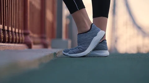 Runner kneads feet before jogging Stock Footage 117542955