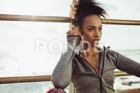 Runner listen music in break Stock Photos