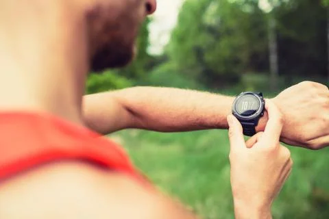 Runner looking checking sport watch Stock Photos