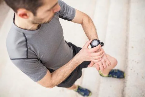 Runner looking at his watch 02 Stock Photos