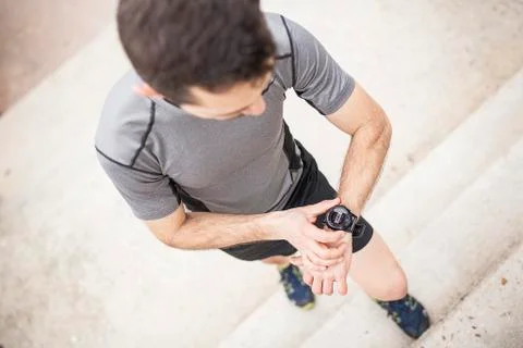 Runner looking at his watch Stock Photos