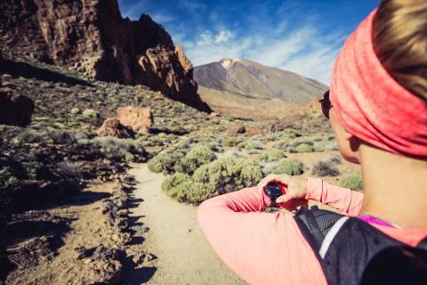 Runner looking at sport watch checking performance Stock Photos