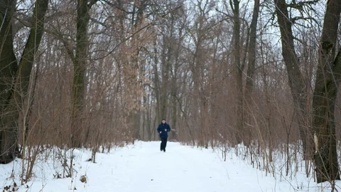 Runner man doing cardio and jogging in snowfall, Christmas snow  Stock Footage 112089462