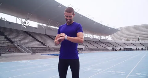 Runner, man or check time for speed goals on track, happy or commitment in Stockbeeldmateriaal 256967236