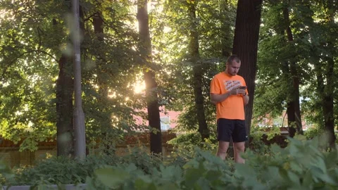 Runner man with a phone and wireless headphones listening to music Video stock 91508274