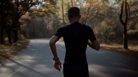 Runner Man Preparing To Triathlon.Running Man On Forest Run Marathon Stock Footage 118840982