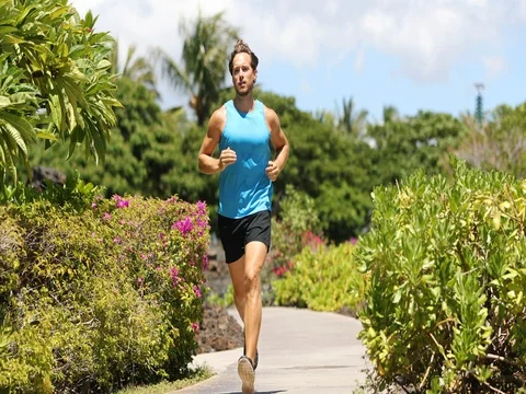 Runner man running on park path exercising on beautiful summer day Stock Footage 76803595