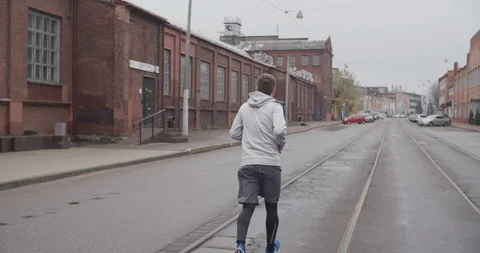 Runner man running on the road in the city. Handsome male athlete training Stockbeeldmateriaal 120498080