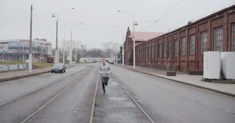 Runner man running on the road in the city. Handsome male athlete training Stock Footage 120584665