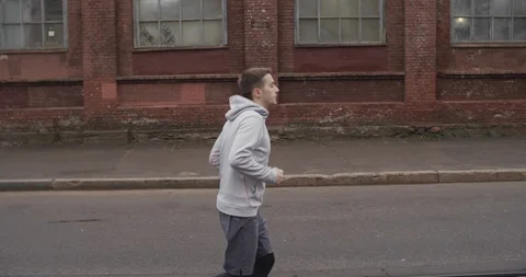 Runner man running on the road in the city. Handsome male athlete training cardi Stock Footage 120776104