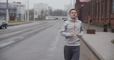Runner man running on the road in the city, listening to music on headphones. 스톡 동영상 121544441