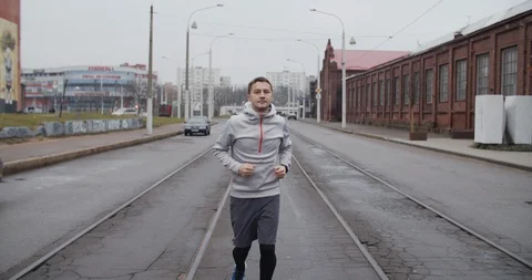 Runner man running on the road in the city. Handsome male athlete training cardi Stock Footage 121545111