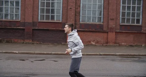 Runner man running on the road in the city. Handsome male athlete training Stock Footage 122245320