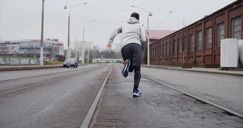 Runner man running on the road in the city. Handsome male athlete training Stock Footage 122246067