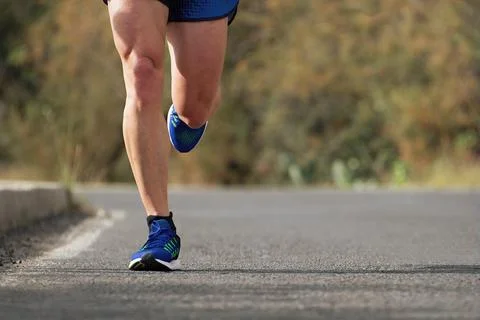 Runner man running on road training for marathon Stock Photos