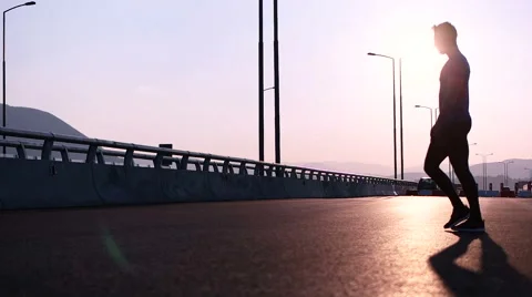 Runner man stretching and resting after running on  road.Handsome Caucasian m Stock Footage 67333892