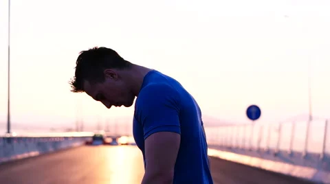 Runner man stretching and resting after running on  road.Handsome Caucasian m Stock Footage 67359186