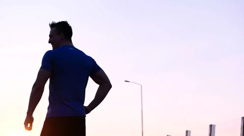 Runner man stretching and resting after running on  road.Handsome Caucasian m Video stock 67363413