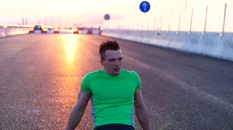 Runner man stretching and taking rest on road. Handsome Caucasian male fitnes Video stock 67367680
