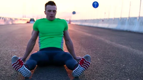 Runner man stretching and taking rest on road. Handsome Caucasian male fitnes Video stock 67368139