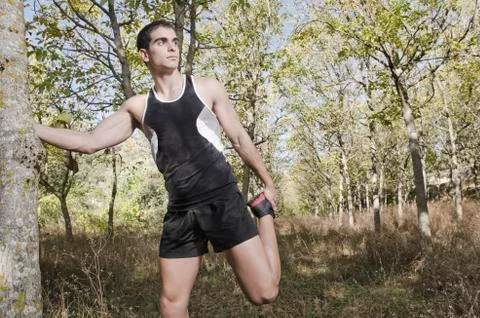 Runner man warming in theforest Stock Photos