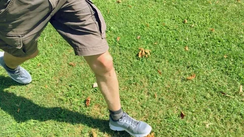 Runner in a meadow with view of his legs and shorts Stock Footage 120519363