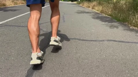 Runner moves swiftly along sunlit pavement. Energy and endurance concept Stock-Footage 337220047