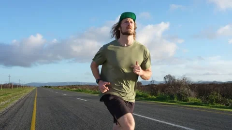 Runner on the open road feeling free and alive Stock Footage 340218917