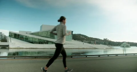 Runner outside Oslo Opera House Video stock 143162471