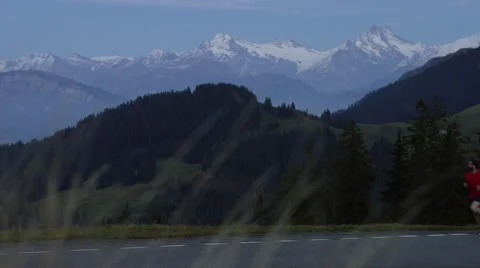 Runner passes through frame while running in the mountains in the early evening Video stock 63025250
