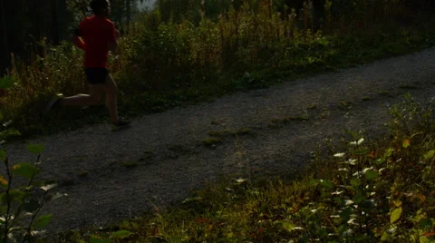 Runner passes through frame while running in the mountains. Stock Footage 63028984