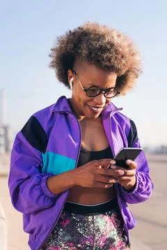 Runner playing music on phone using earphones Stock Photos