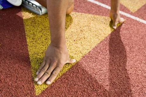 Runner Positioned On Starting Block Stock Photos