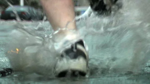 Runner puddle splash. Closeup. Video stock 50628967