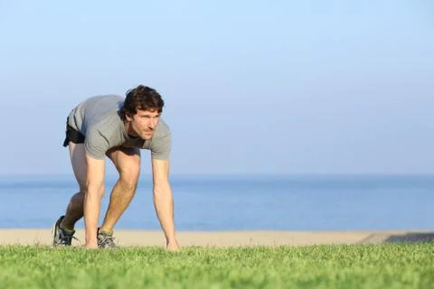 Runner ready to run on the grass Stock Photos