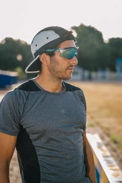 Runner resting after track training on a sunny day Foto stock