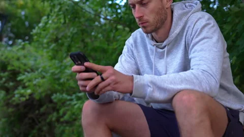 Runner Reviewing Longevity Ring Data in Mobile App Stock Footage 347812467