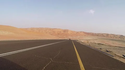 Runner on a road in the desert Stock Footage 84131915