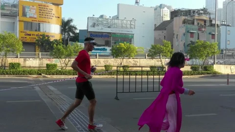 Runner running with ao dai at the marathon event in Ho Chi Minh city in Novem Stock Footage 157119156