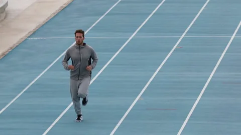 Runner. Running man training on athletics track and field stadium. Male athlete Stock Footage 220146033