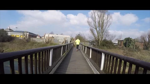 Runner running over the bridge Stock Footage