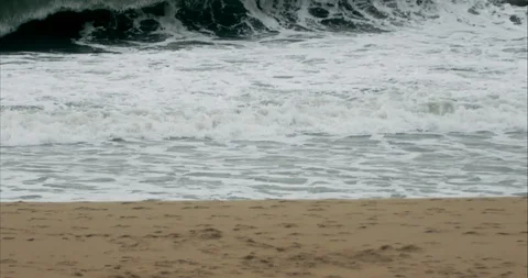 Runner on the Seashore with Big Waves in Slowmotion Stock Footage 115830615