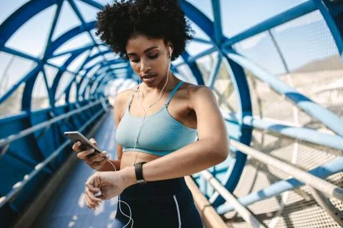 Runner setting up her smart watch for run Foto stock