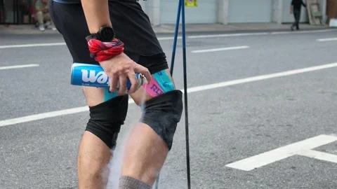 Runner Spraying Cooling Spray on Leg at Aid Station, Lushan Stock Footage 346718018