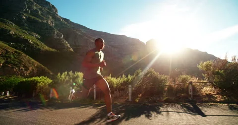 Runner sprinting in slow motion on mountain road Stock Footage 48372030